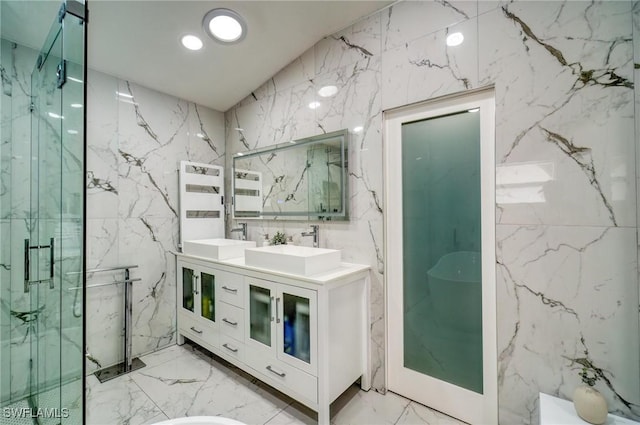 bathroom with vanity, tile walls, and walk in shower