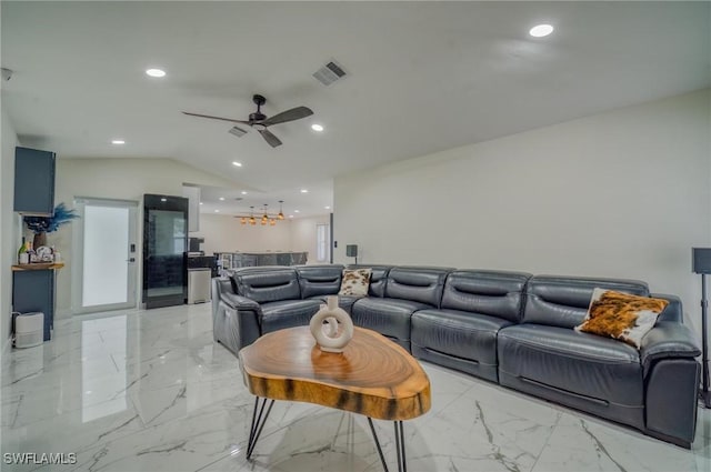 living room featuring ceiling fan, indoor bar, and vaulted ceiling