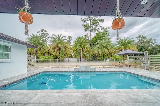 view of swimming pool with a patio