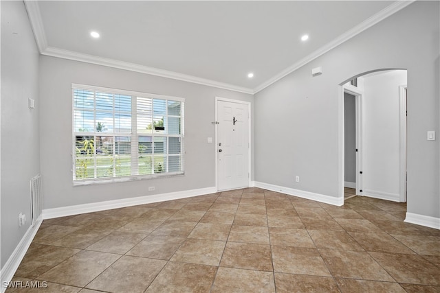 tiled empty room featuring ornamental molding