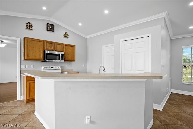 kitchen with lofted ceiling, light tile patterned flooring, white range with electric stovetop, and ornamental molding