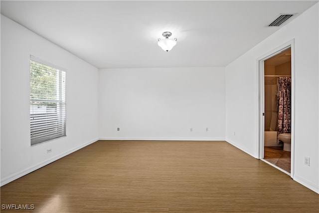 empty room with hardwood / wood-style floors