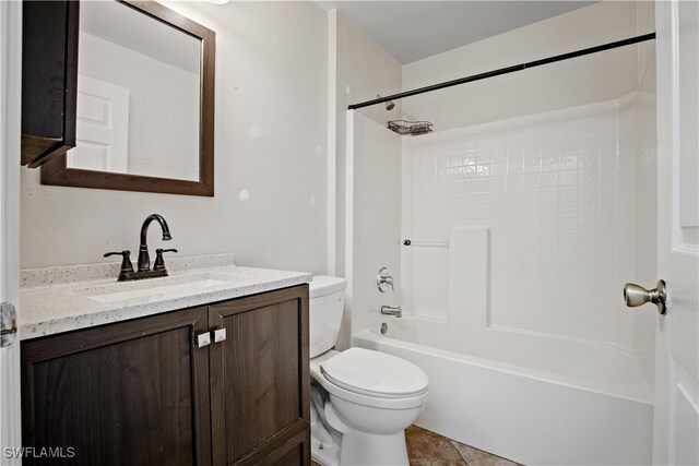 full bathroom featuring tile patterned flooring, toilet, vanity, and shower / washtub combination