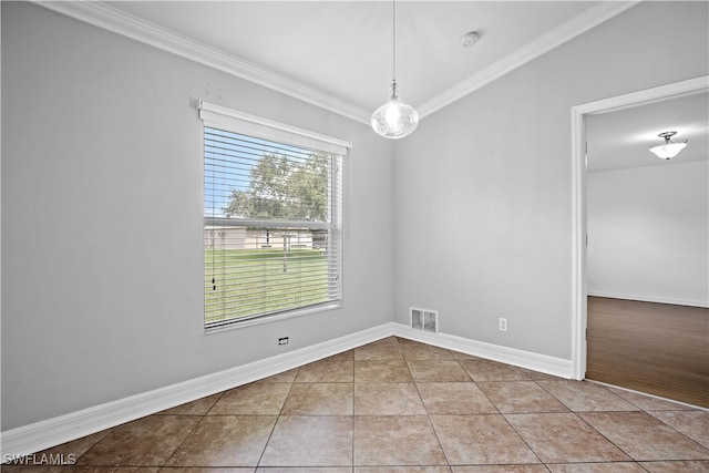 tiled empty room featuring ornamental molding