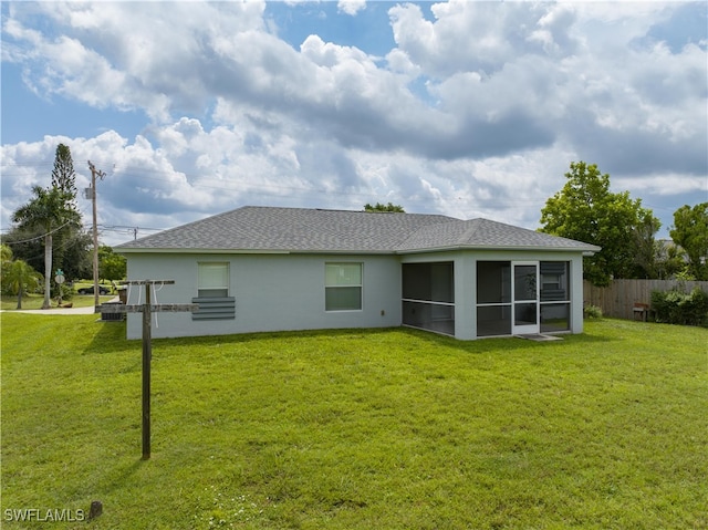 back of house with a sunroom and a lawn