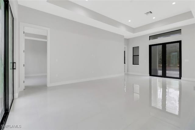 unfurnished room with a tray ceiling