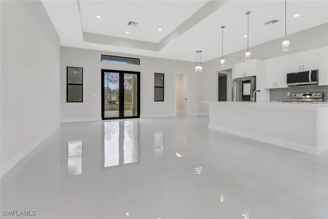 interior space with sink and a raised ceiling