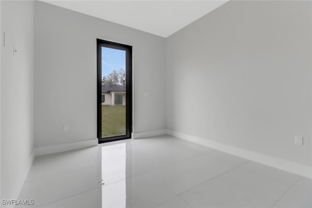 spare room featuring tile patterned flooring