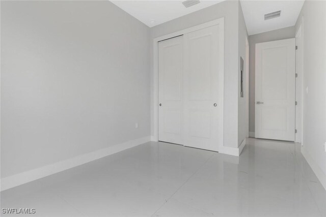 unfurnished bedroom with tile patterned floors and a closet