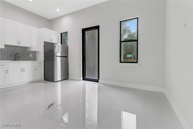 interior space with light tile patterned flooring and sink