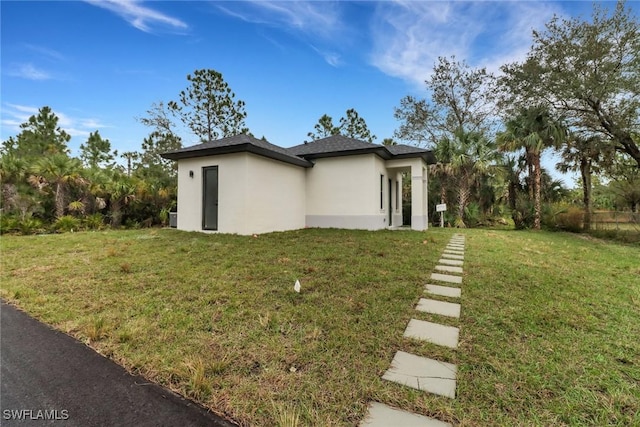 view of side of property with a yard