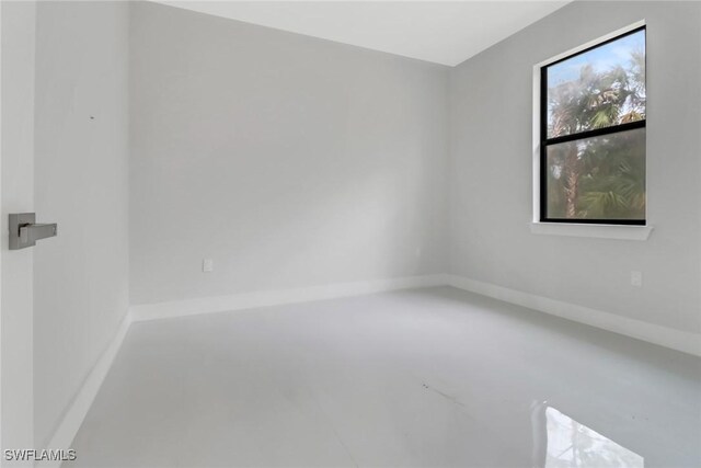 unfurnished room featuring concrete floors