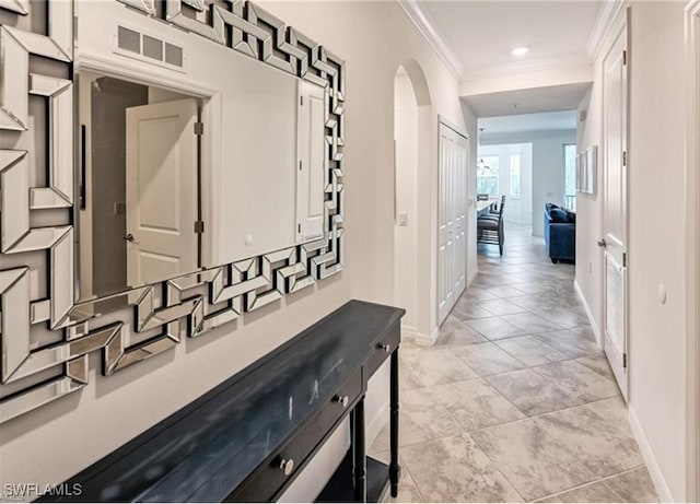 hallway with light tile patterned floors and ornamental molding