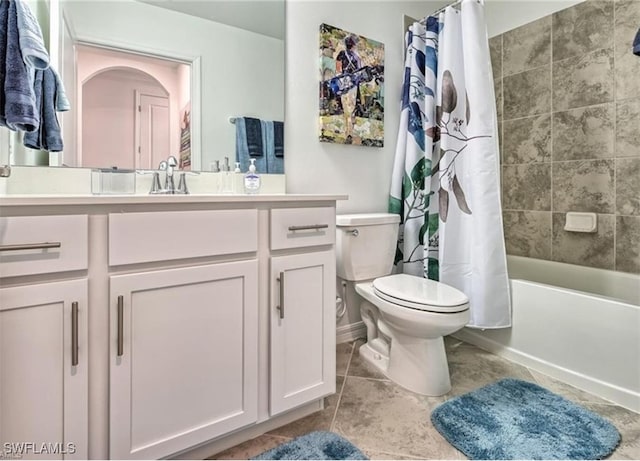 full bathroom featuring tile patterned flooring, vanity, shower / tub combo with curtain, and toilet