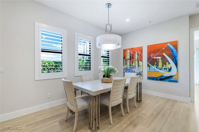 kitchen featuring appliances with stainless steel finishes, light wood-type flooring, tasteful backsplash, and white cabinetry