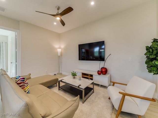 living room with ceiling fan and light hardwood / wood-style floors