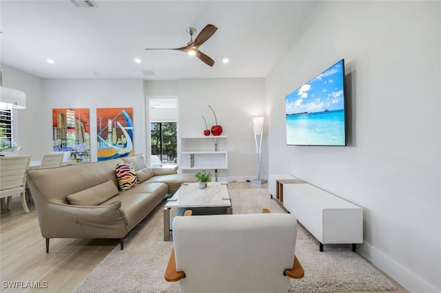 living area featuring recessed lighting, baseboards, light wood-style floors, and ceiling fan