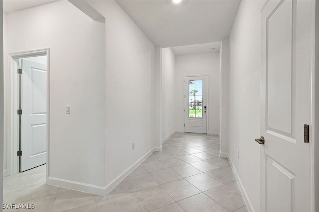 corridor featuring light tile patterned flooring