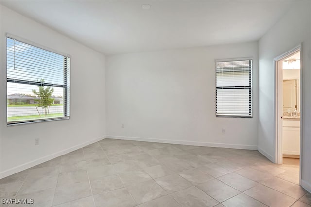 empty room with light tile patterned flooring