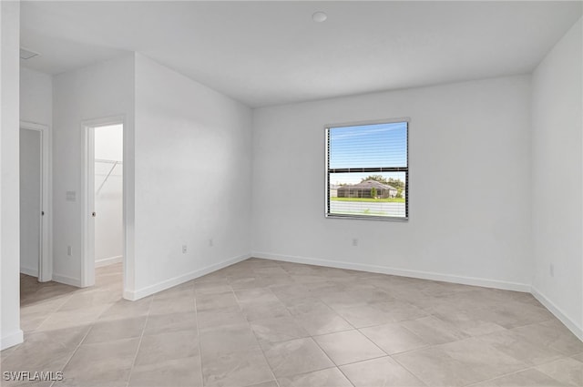 spare room with light tile patterned floors