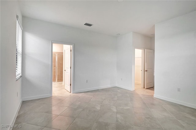 spare room featuring visible vents and baseboards