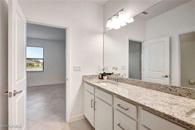 bathroom featuring tile patterned floors, visible vents, baseboards, and vanity