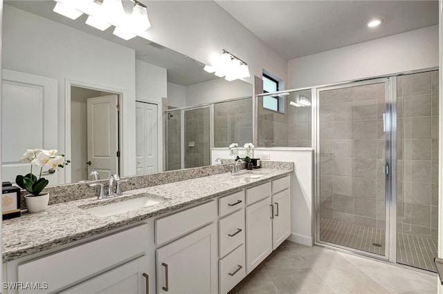 bathroom with tile patterned flooring, vanity, and an enclosed shower