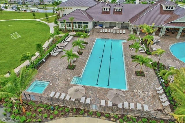 view of pool featuring a community hot tub and a patio area