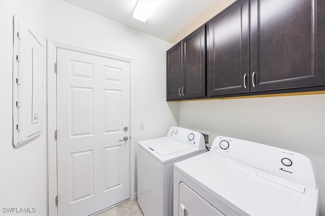 laundry area featuring cabinets and washing machine and clothes dryer