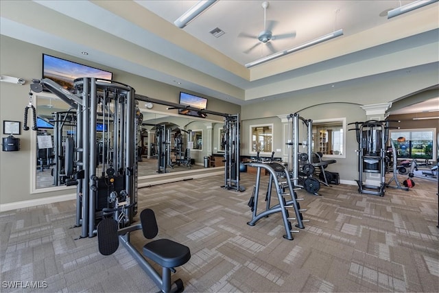 exercise room featuring carpet flooring, ornate columns, and ceiling fan