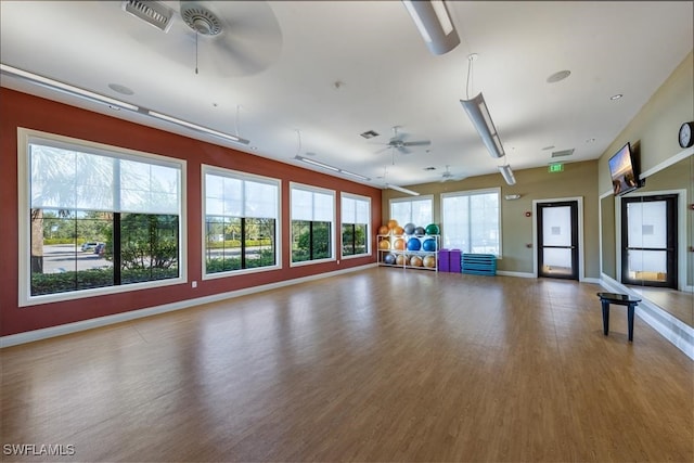 exercise area with wood-type flooring and ceiling fan