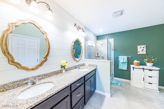 bathroom with vanity, a shower with shower door, and tile patterned flooring