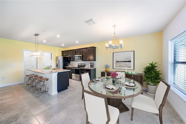 dining room with a notable chandelier and sink