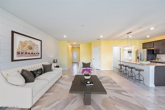 tiled living room featuring wooden walls