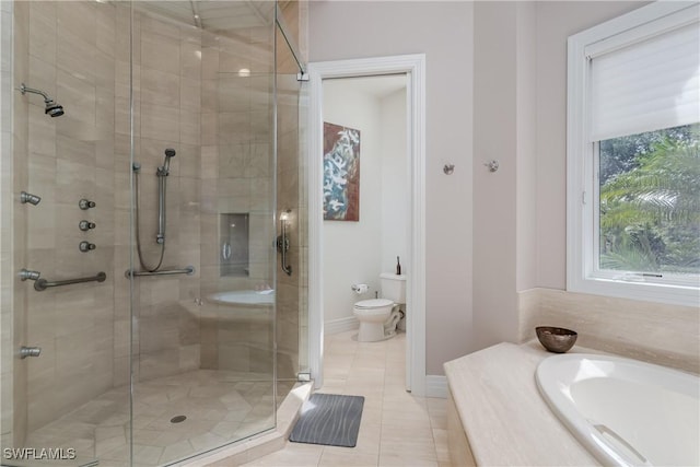 full bath featuring a stall shower, baseboards, toilet, a garden tub, and tile patterned flooring