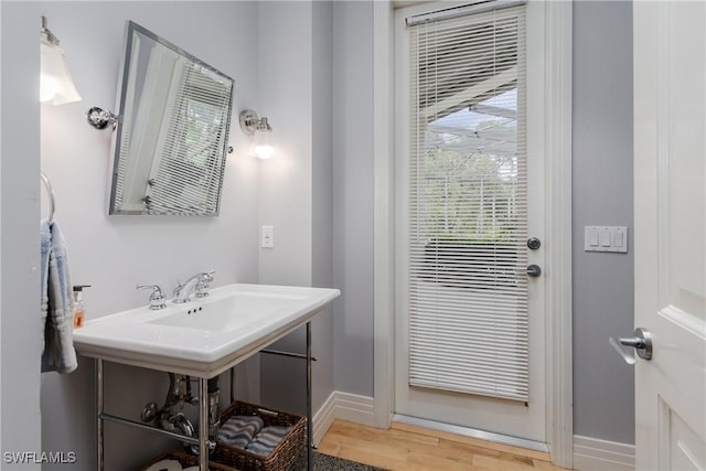 bathroom featuring wood finished floors and baseboards