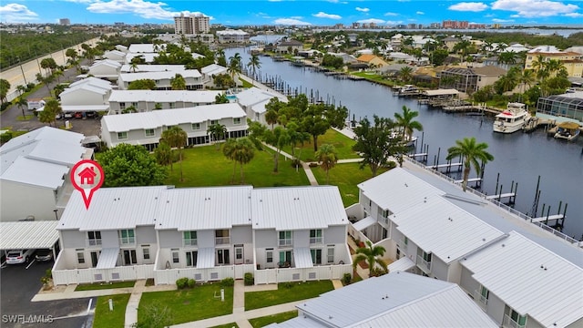 drone / aerial view featuring a residential view and a water view