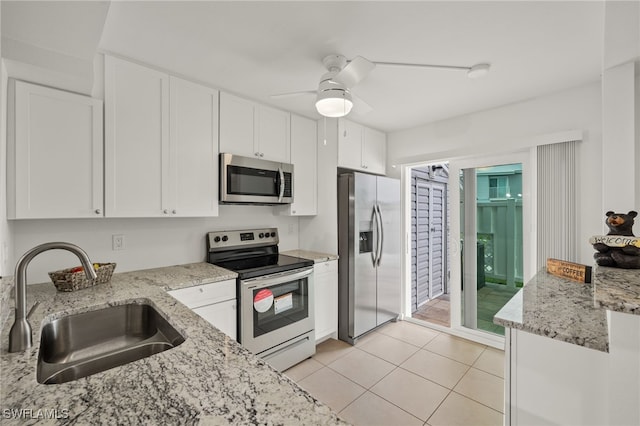 kitchen featuring sink, light stone countertops, ceiling fan, stainless steel appliances, and white cabinets