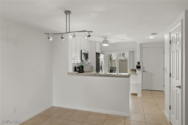 kitchen with visible vents, a ceiling fan, stainless steel appliances, white cabinets, and light tile patterned flooring