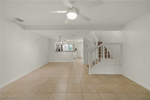 spare room featuring ceiling fan and light tile patterned floors