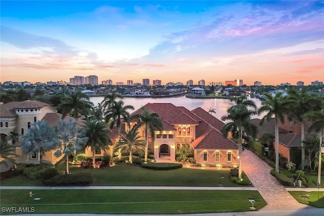 aerial view at dusk with a water view