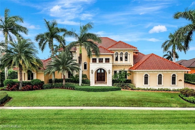 mediterranean / spanish-style home featuring a front yard