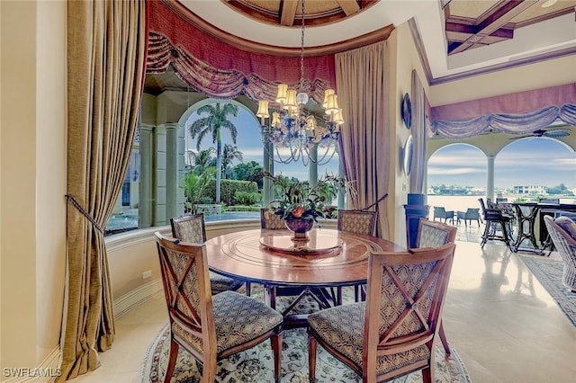 dining room with a water view and an inviting chandelier