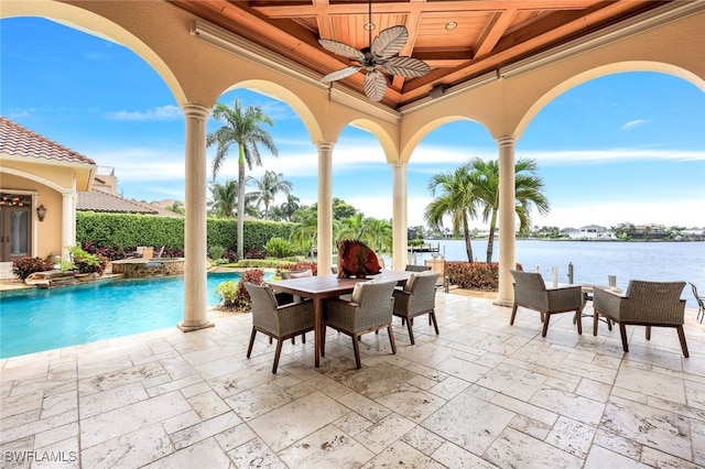 view of patio / terrace featuring ceiling fan and a water view