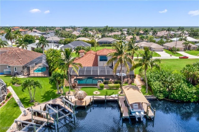 birds eye view of property featuring a water view and a residential view