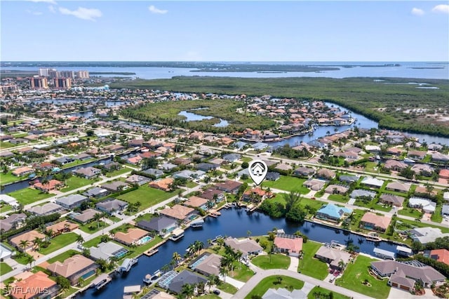 birds eye view of property featuring a residential view and a water view