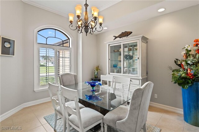 dining space with crown molding, light tile patterned floors, and an inviting chandelier