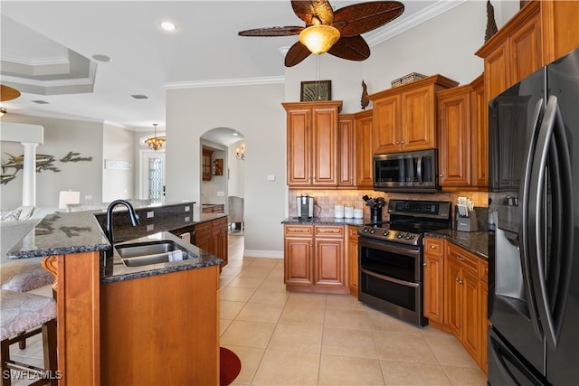 kitchen featuring a breakfast bar, backsplash, sink, ornamental molding, and stainless steel appliances