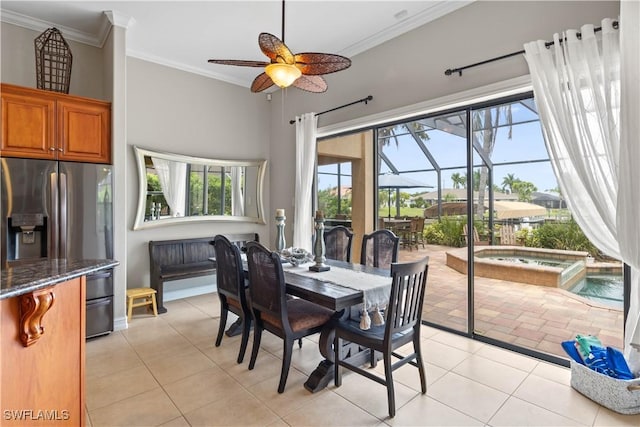 dining area with light tile patterned floors, a ceiling fan, a sunroom, and crown molding