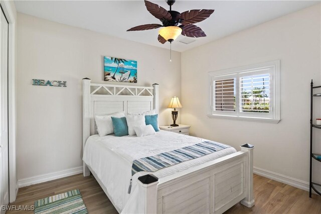 bedroom featuring ceiling fan, hardwood / wood-style flooring, and a closet